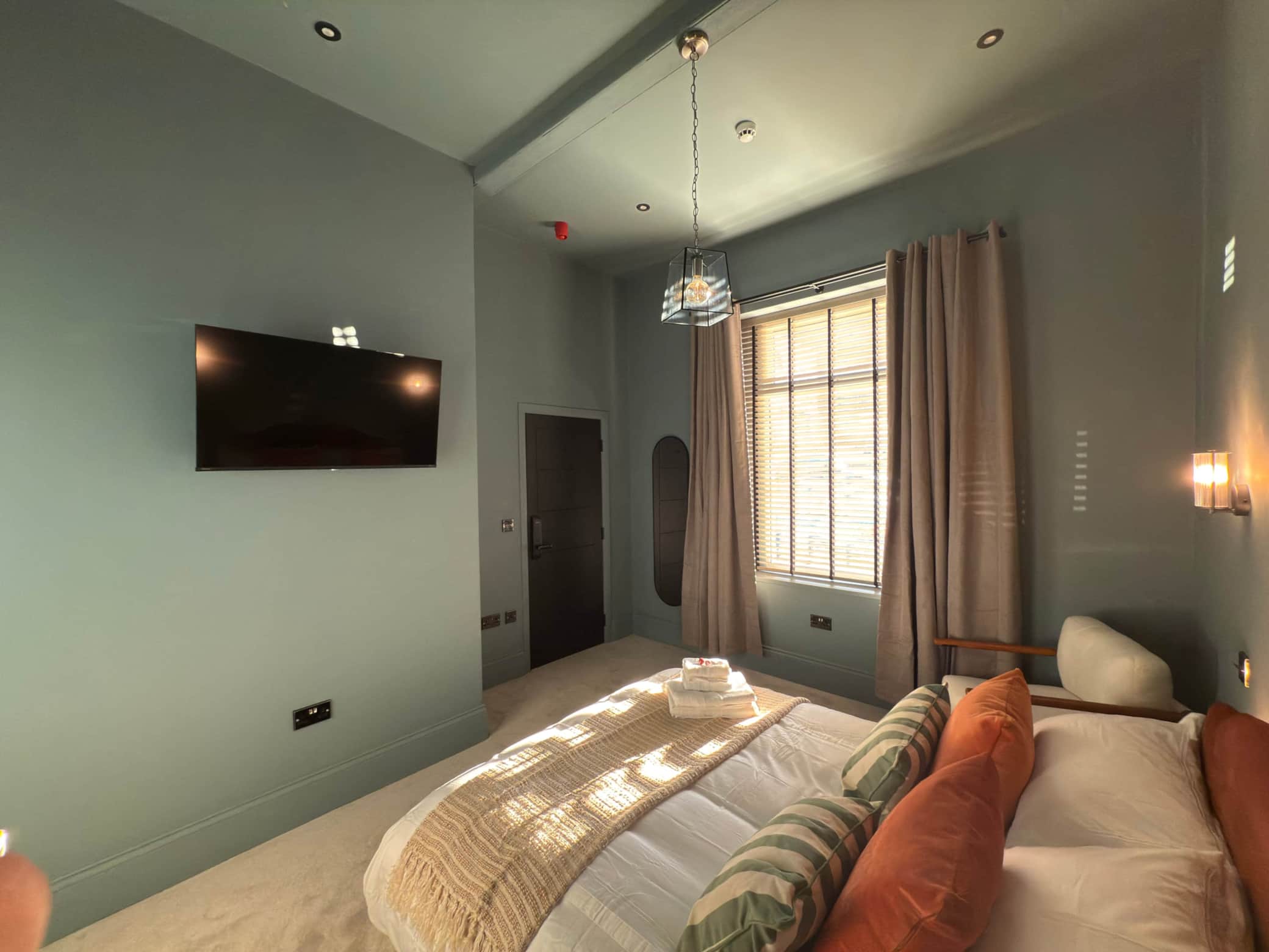 Akroyd House guest room with wall mounted TV